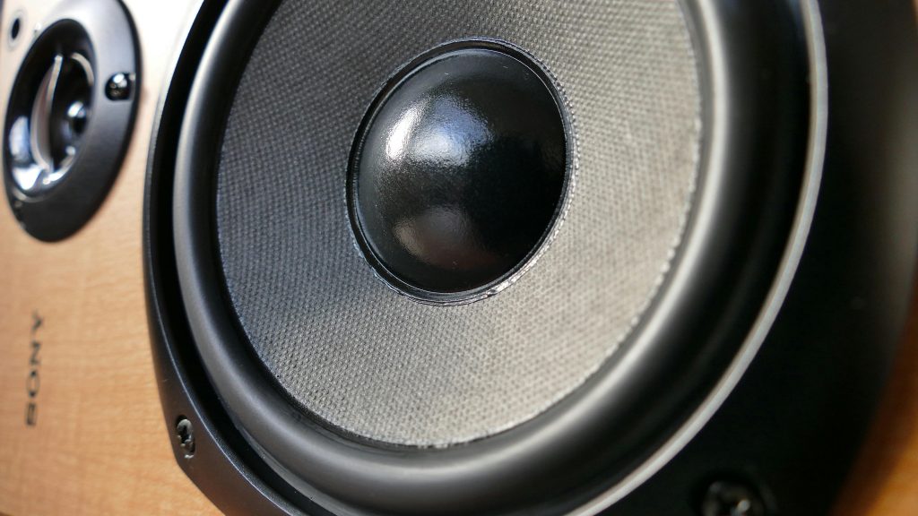 Detailed close-up of a modern speaker woofer cone showing texture and design.